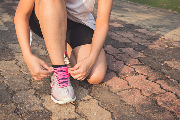 Woman tying tennis shoe
